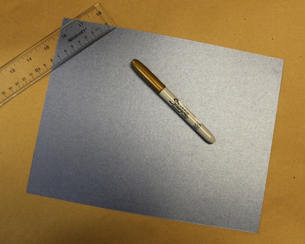 materials for DIY checkers: blue card stock, ruler, gold Sharpie