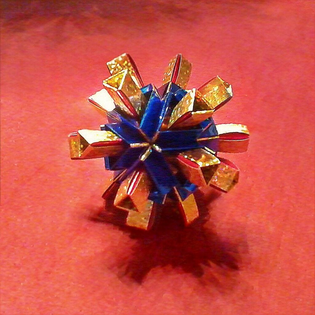Gold and Blue Star small gold and blue star shaped origami against red background