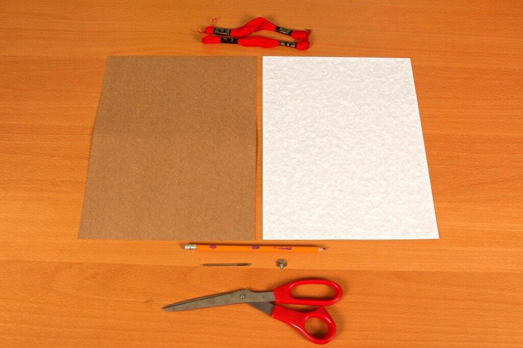 Materials for DIY embroidered card Cardstock, cardboard, pencil, twine, scissors