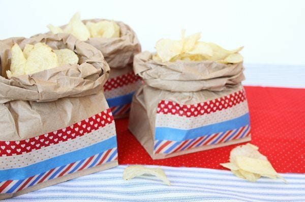 brown kraft lunch bags decorated with red, white, and blue patterned stripes
