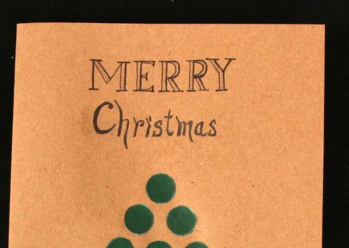 Handwritten Christmas Card "Merry Christmas" written on brown card stock