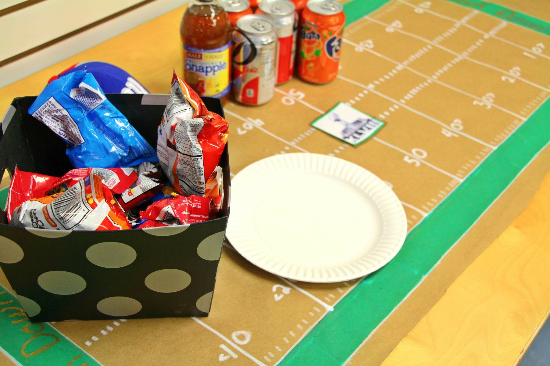 snacks and plates on football field tablecloth football field tablecloth, snacks