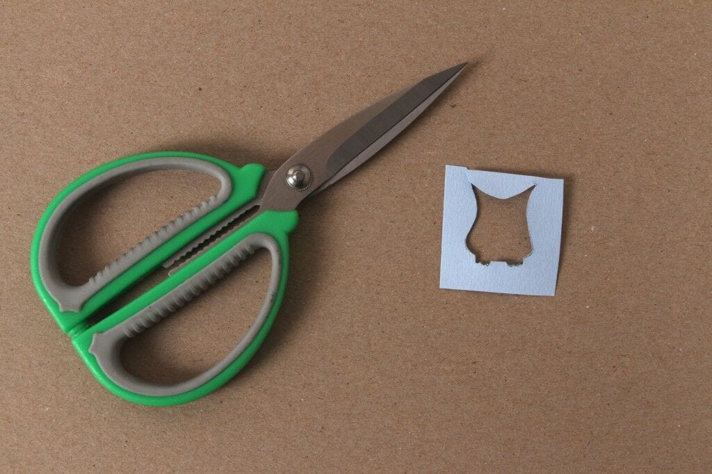 scissors, small paper with shape cut out