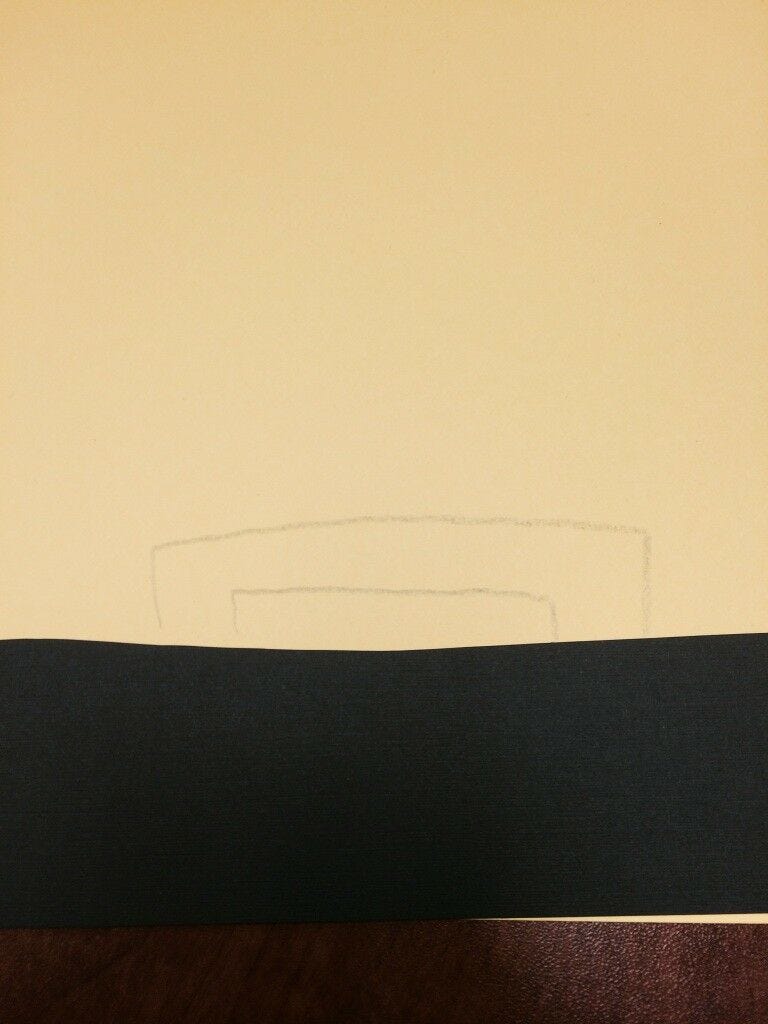 yellow paper with buckle shape traced in pencil
