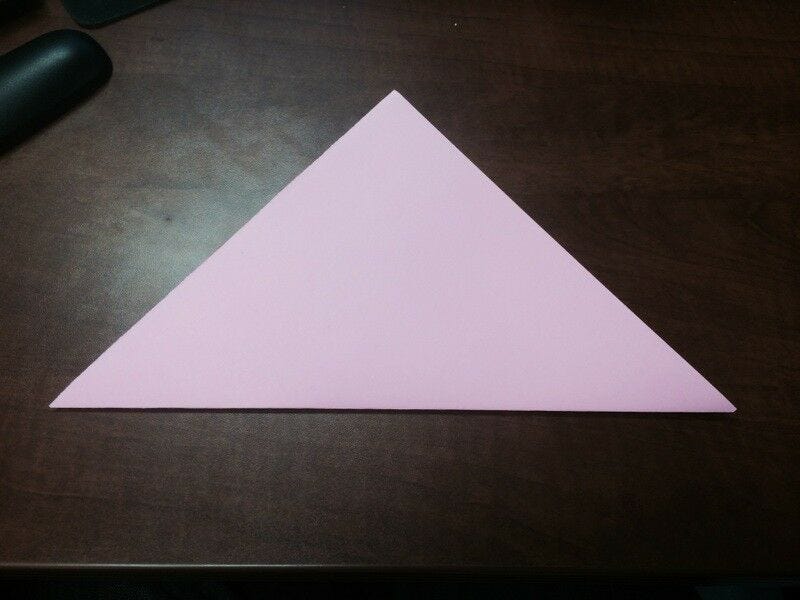 light pink paper folded in half to form triangle