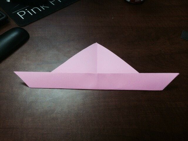 light pink paper triangle with bottom folded up