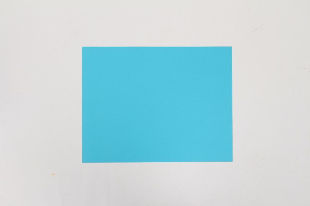 bright blue sheet of cardstock on gray background