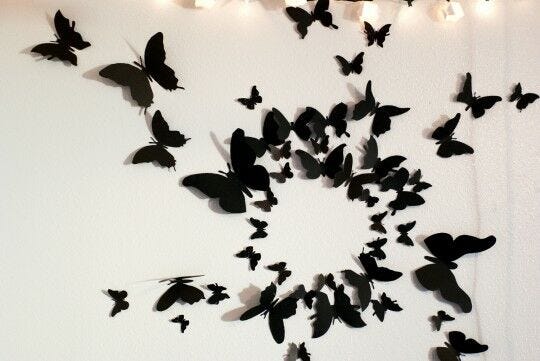 different sized black butterflies wall design with lights