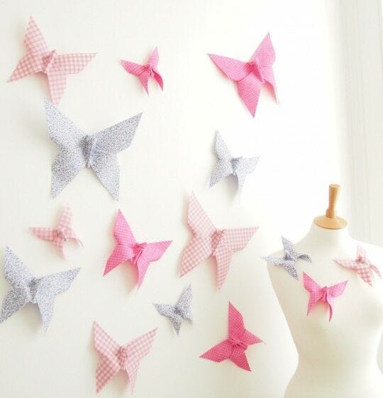 pink patterned butterflies on cream wall with mannequin