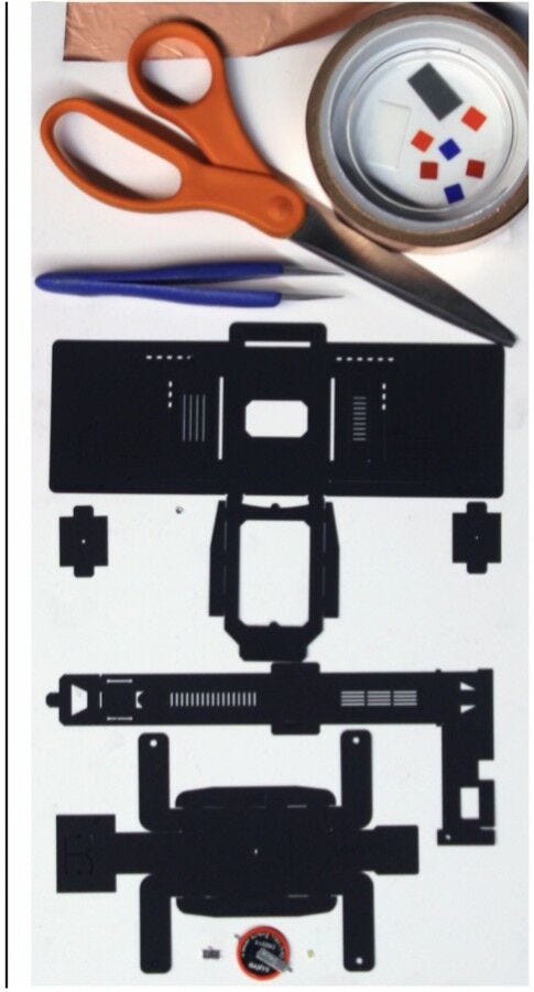 foldscope parts laid out with scissors and tweezers