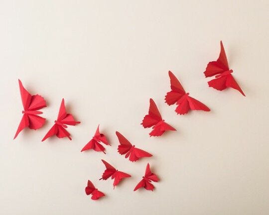 red butterfly design on white wall