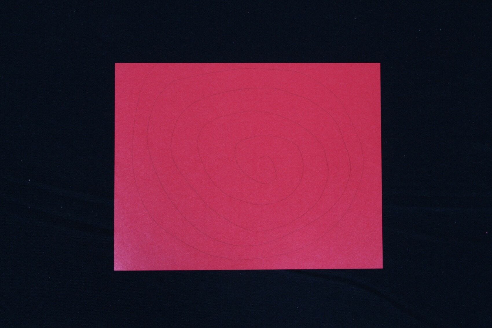 Red paper, spiral drawn on 