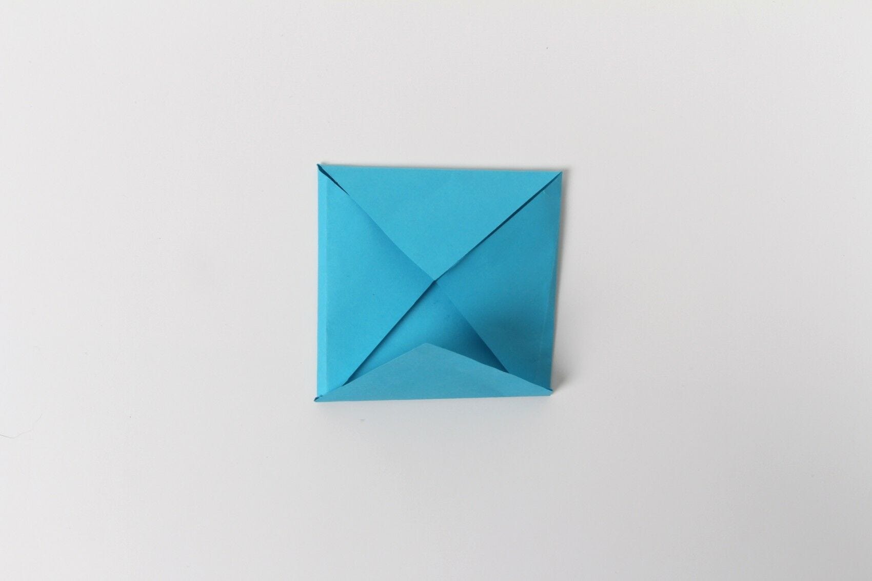 Blue square with corners folded toward center