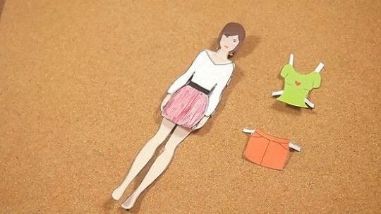 paper doll with outfits completed female paper doll with outfits laying on desk
