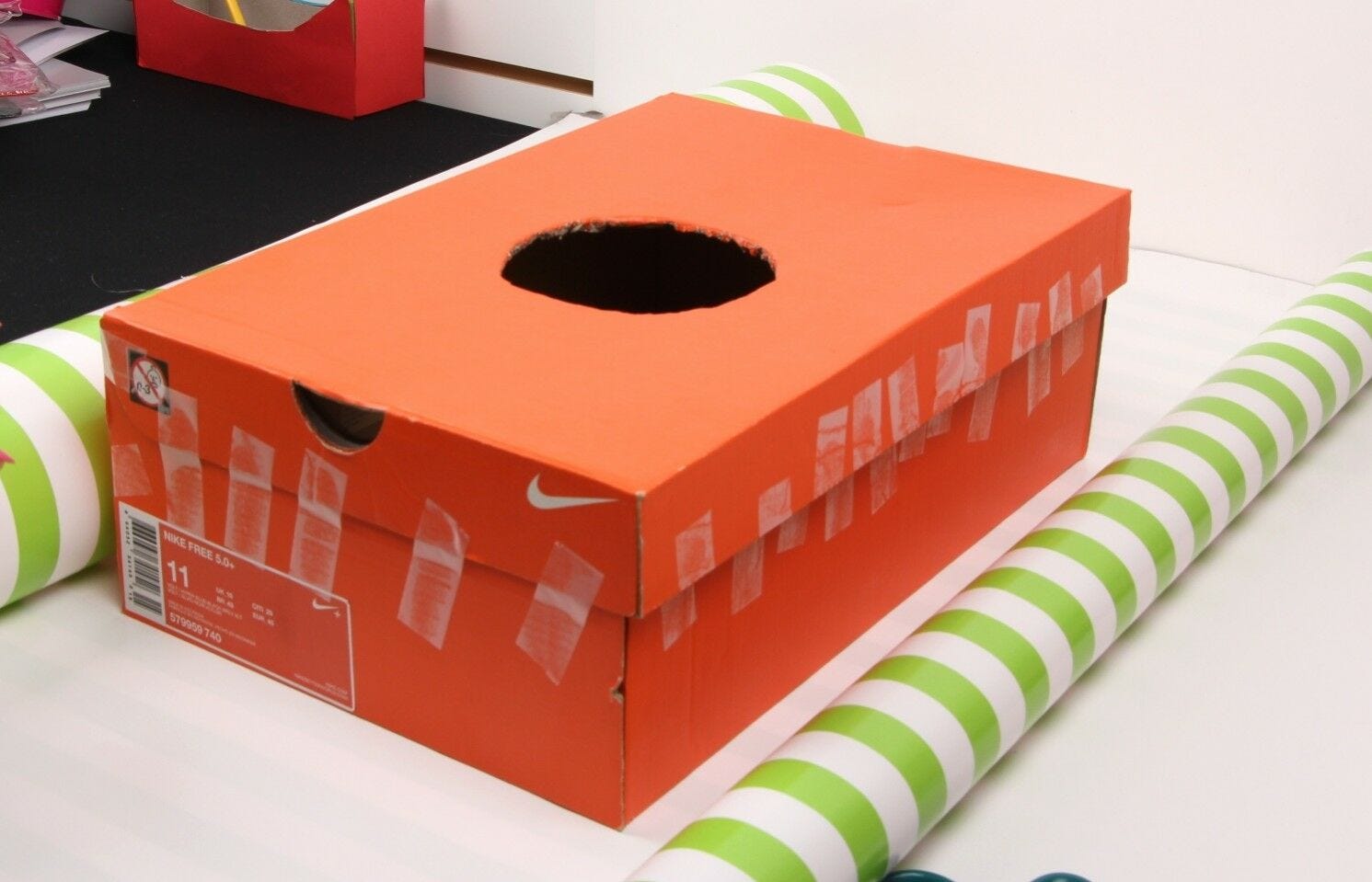 diy birdhouse shoe box with taped sides on wrapping paper roll