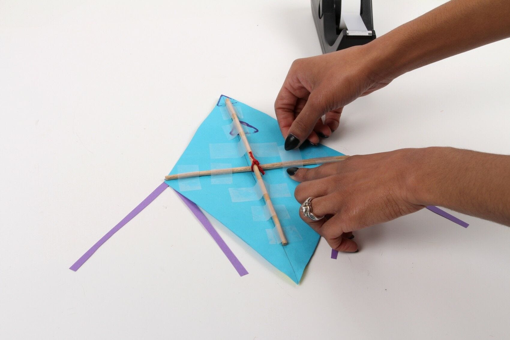 Tape chopsticks to back of kite