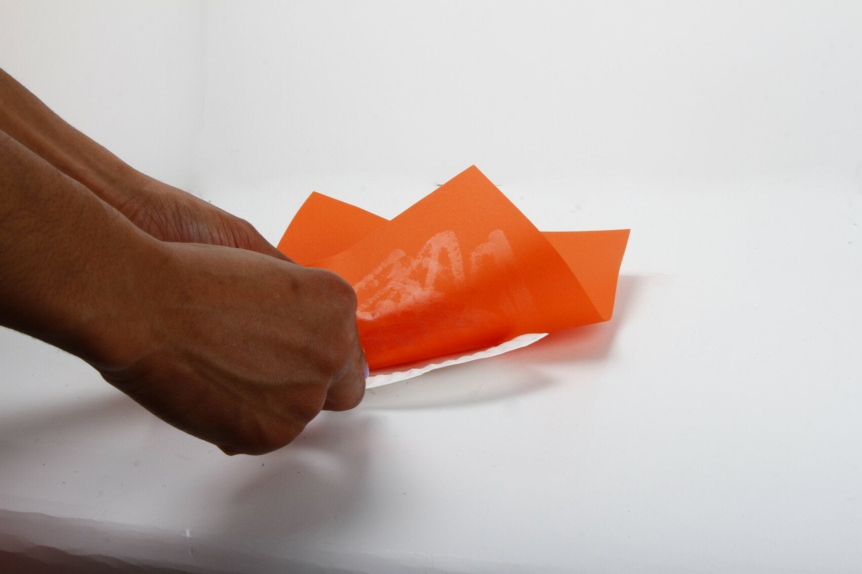 Gluing plate to orange paper gluing paper to plate