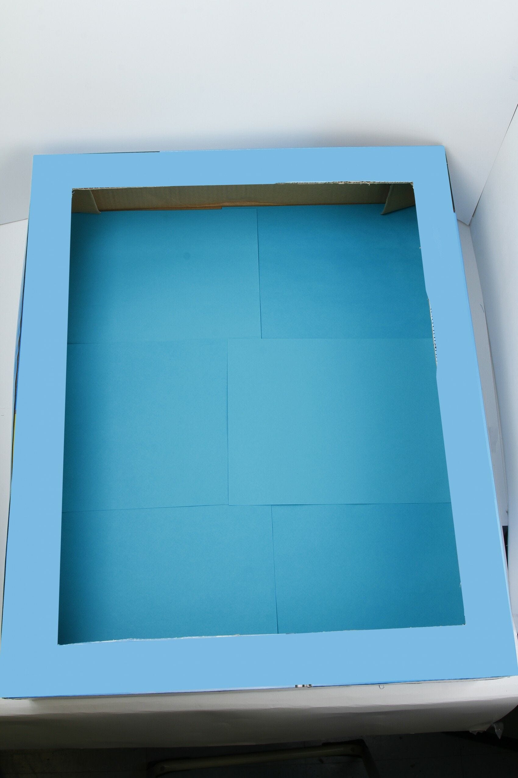 Blue paper glued to inside of box Blue paper in box