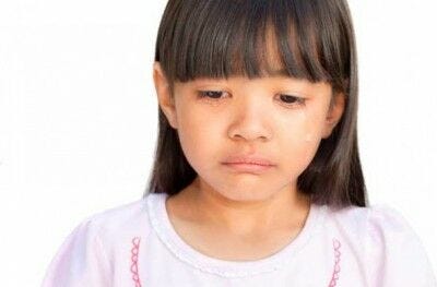 portrait shot of young pre-teen girl crying