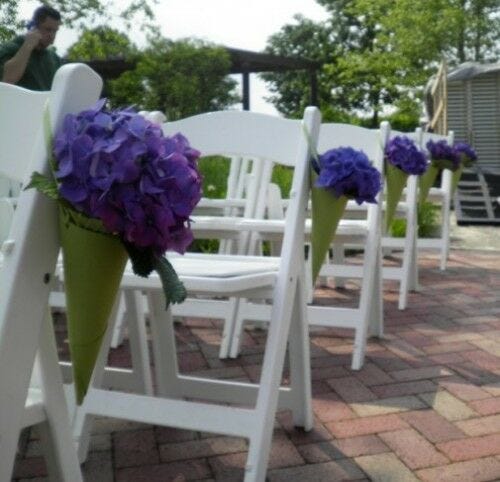 Purple flowers in cones on chairs