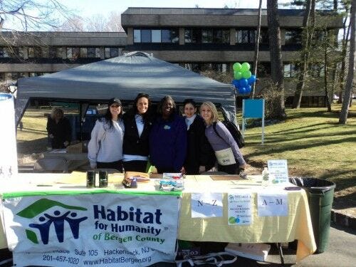 habitat for humanity 5k race to build table with group of women and tent in background