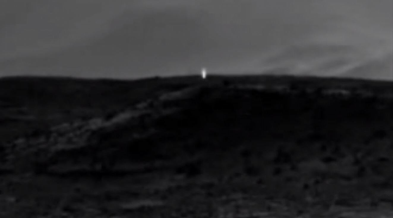 black and white landscape with small light in distance