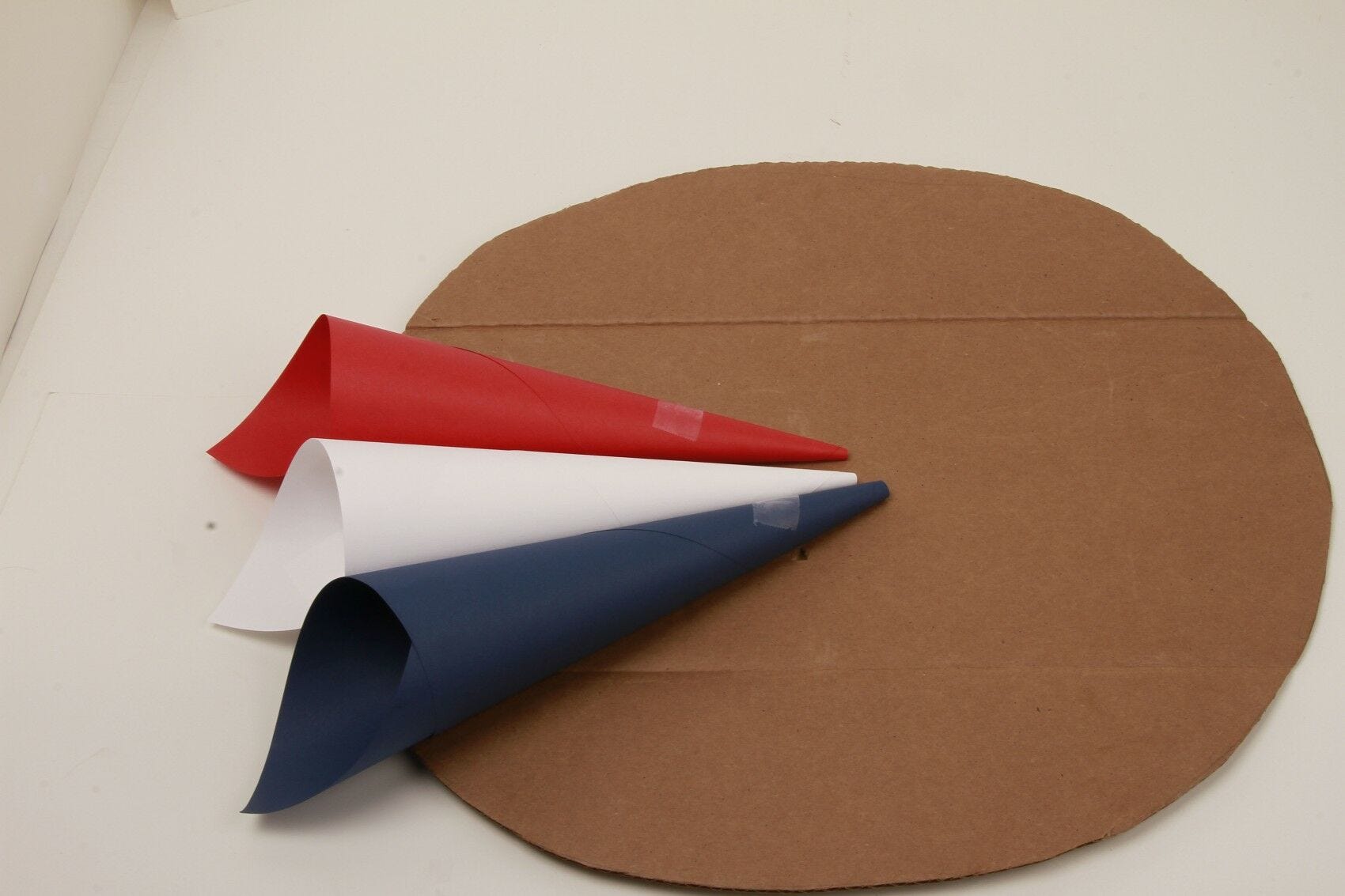 red, white, blue paper cones taped to cardboard circle