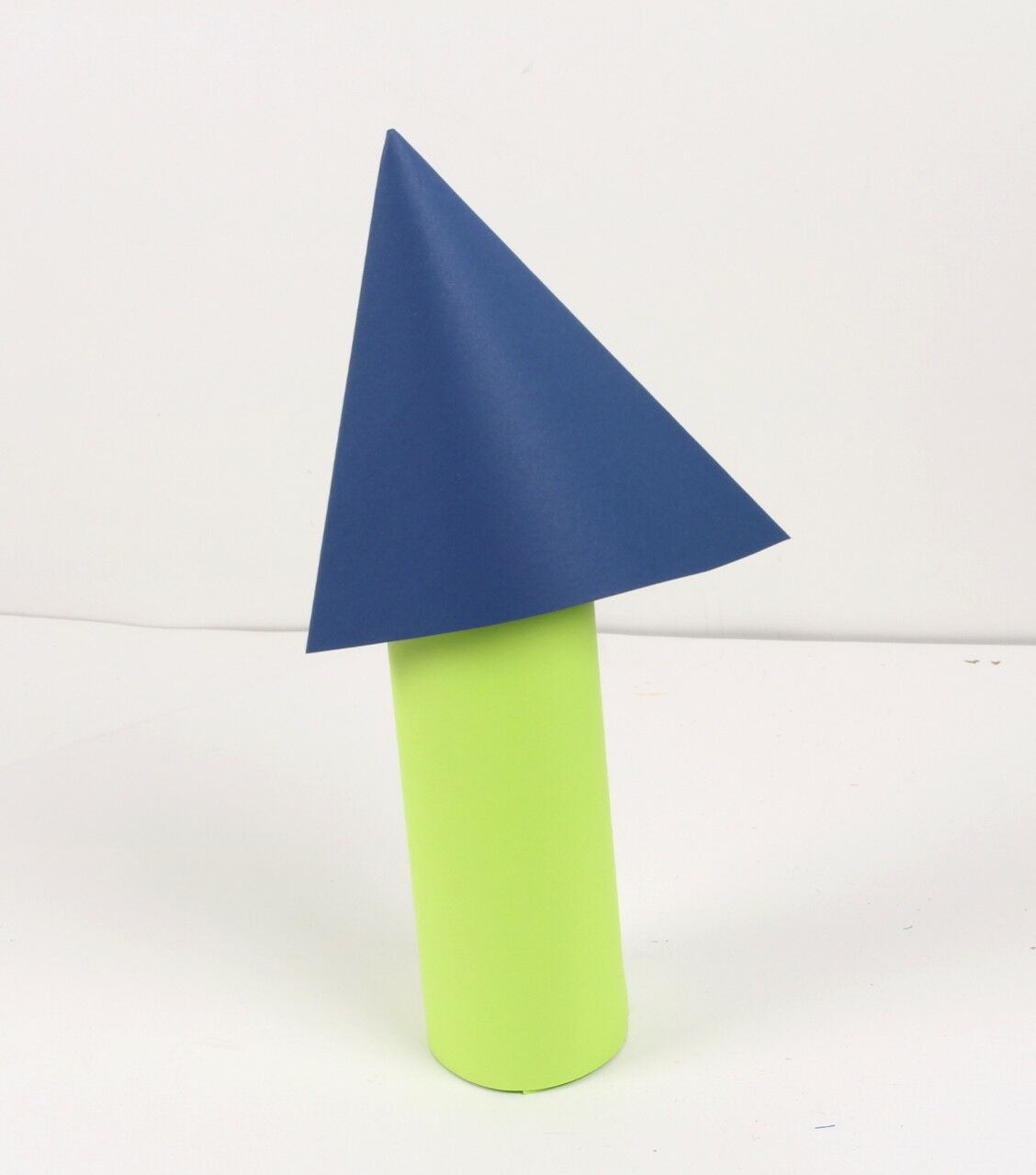 blue paper cone on top of green paper cylinder water bottle spaceship