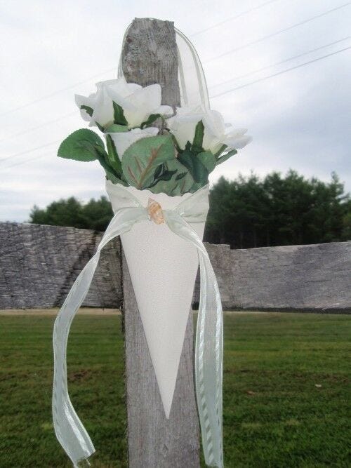 Flowers in cone on fence