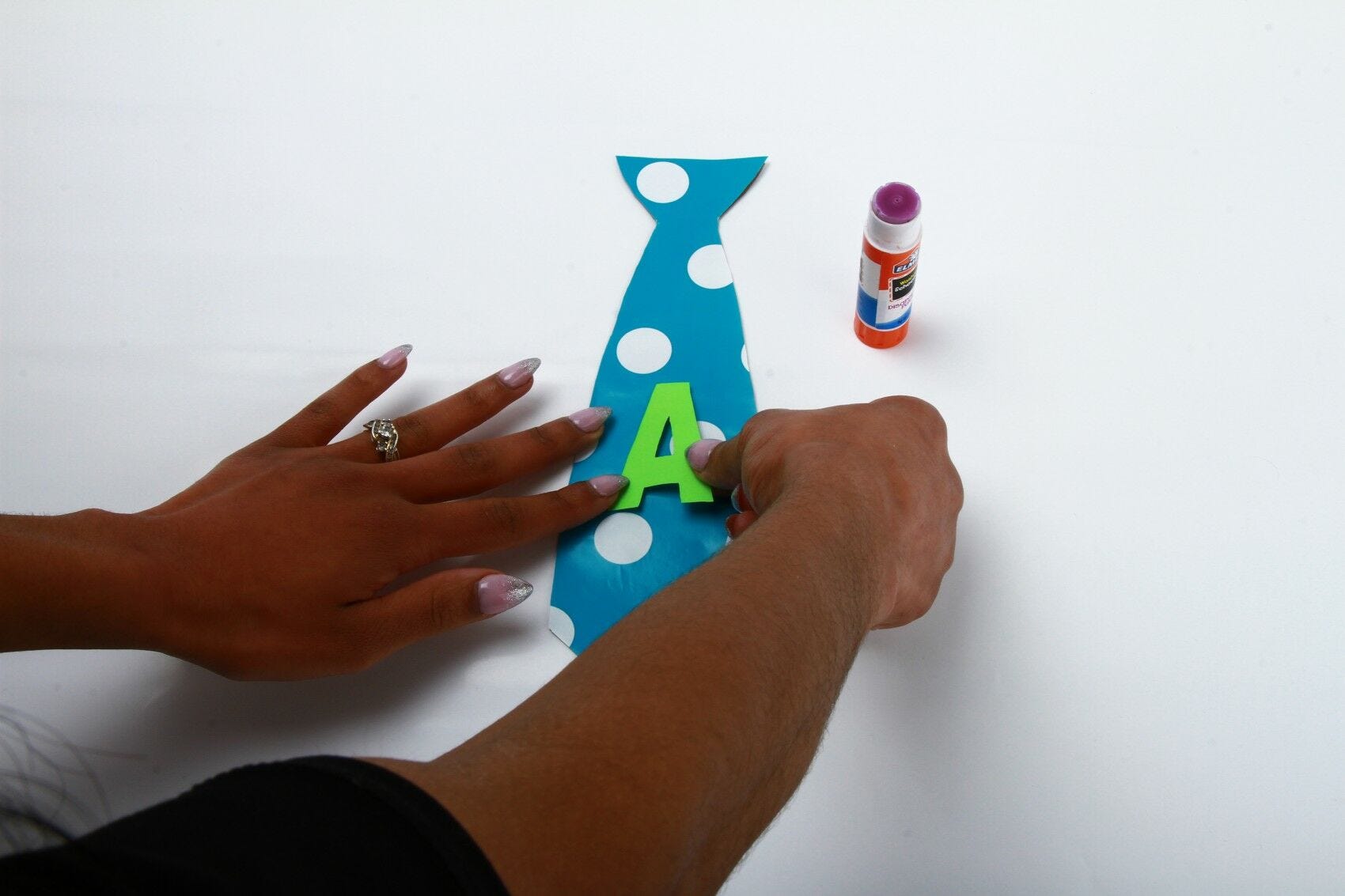 gluing letter A to cardstock necktie