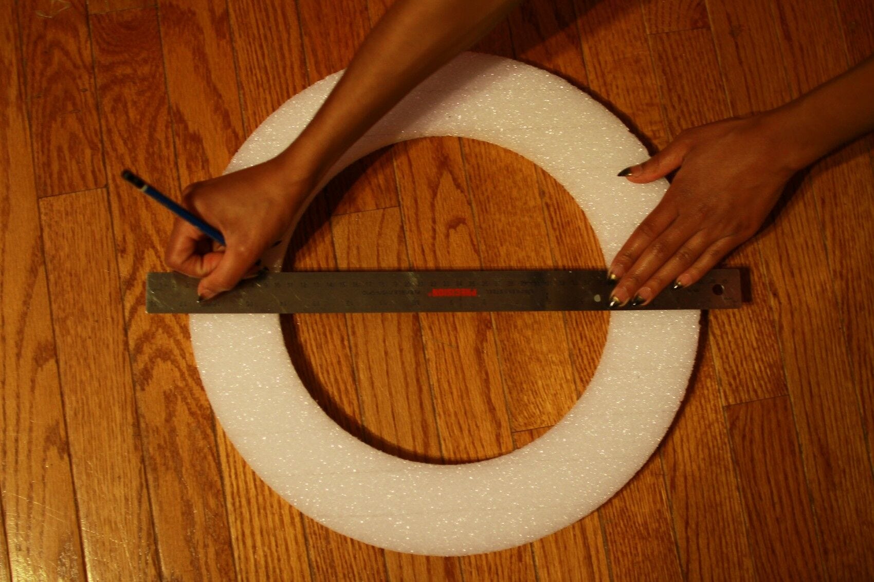 ruler, hands, styrofoam circle 