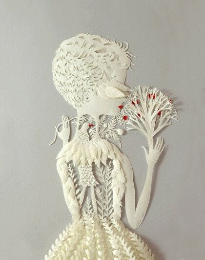 white 3D papercut design of nature girl with tree in hand