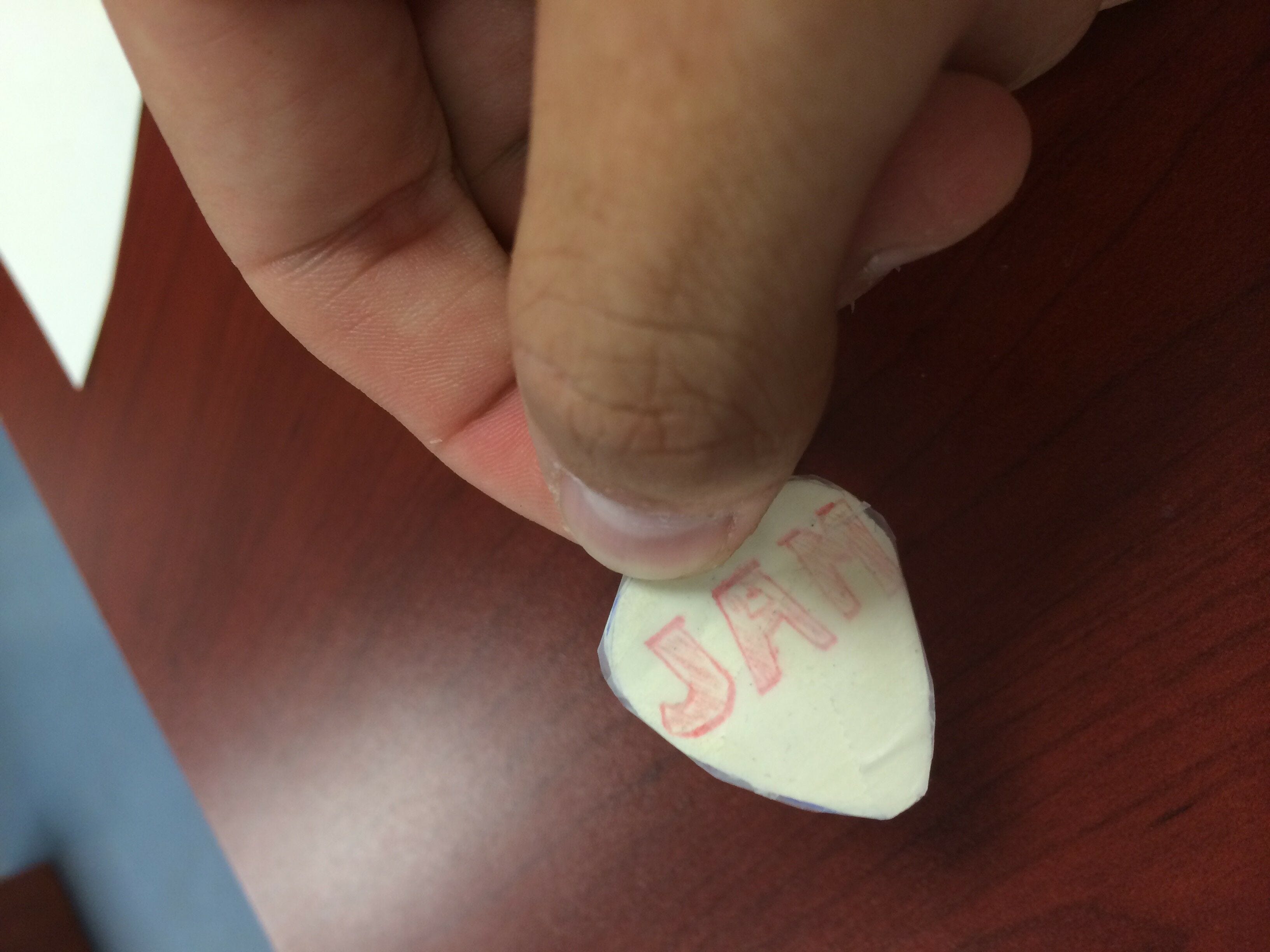 diy white paper guitar pick with red jam logo