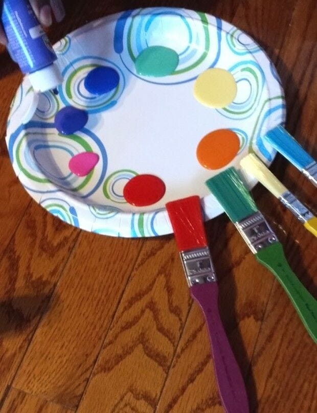 paint drops on paper plate, brushes