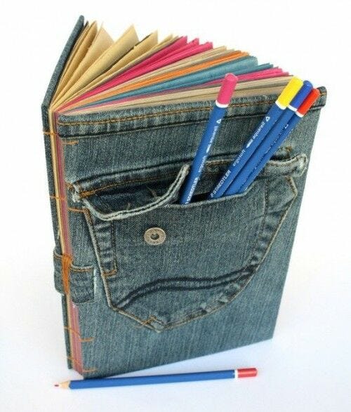 denim book cover with open pocket and colored pencils sticking out