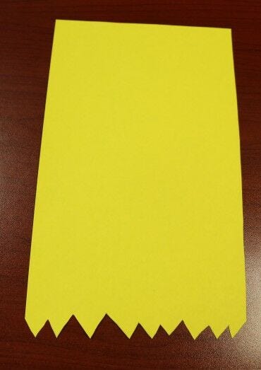 yellow paper with zigzags cut on button for pencil school craft