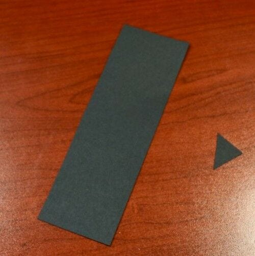 small black paper triangle and long black rectangular paper