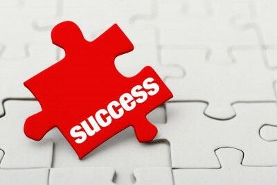 red puzzle piece, "success"