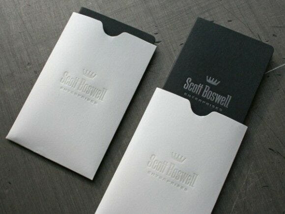 black business cards in white envelopes