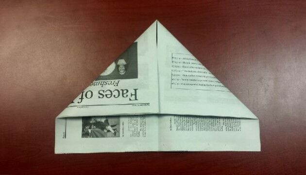 Newspaper, corners folded down