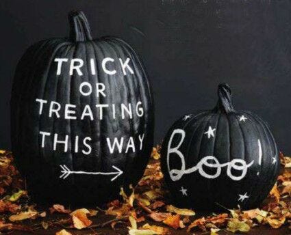 pumpkin carving alternatives: black pumpkins with white chalk paint text and decor