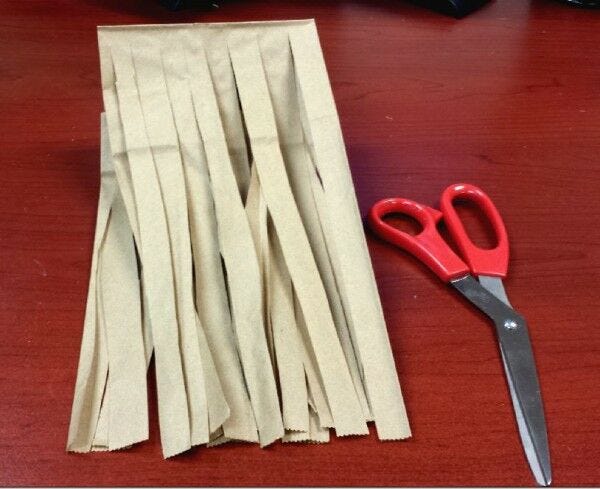 paper bag cut into strips, scissors