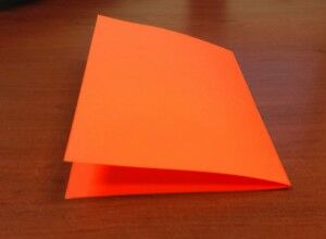 Orange sheet of paper folded in half