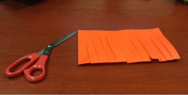 Scissors, orange paper cut