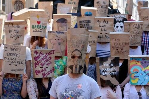 group of people wearing paper bags