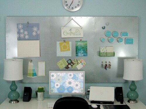 Silver magnetic bulletin board behind workspace magnetic bulletin board, desk setup