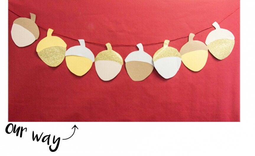 "Our way," acorn garland over red paper Acorn garland over red background, "Our way"