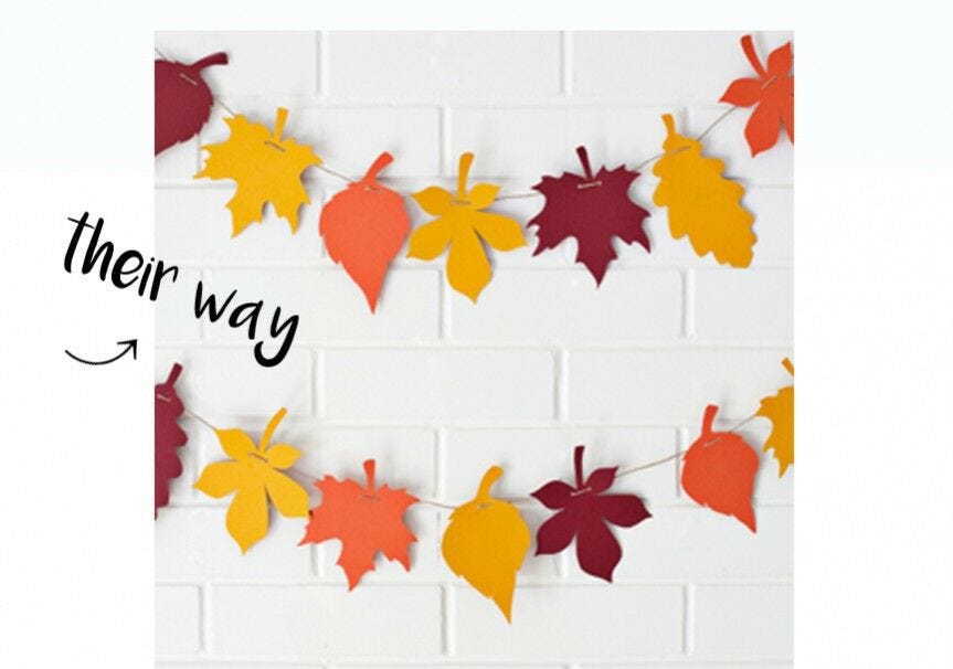 Fall leaf garland on white wall, "their way"