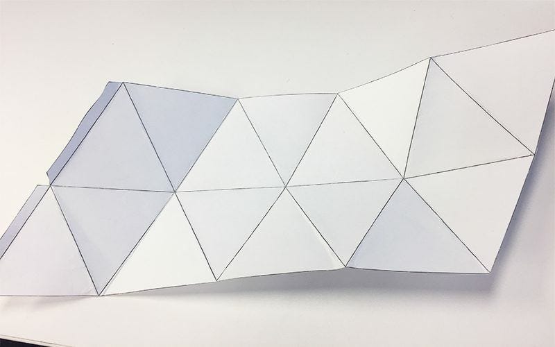 white folded paper with geometric triangle shapes