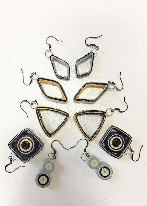 completed diy paper earrings assortment of paper earrings in stacked arrangement